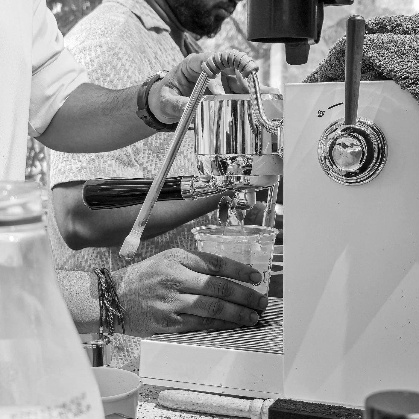 A barista pulling espresso at a Mumbai café